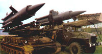 SA-4 missiles being loaded onto launcher from supply truck 