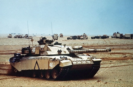 A British Challenger 1 main battle tank moves into a base camp along with other Allied armour during Operation Desert Storm