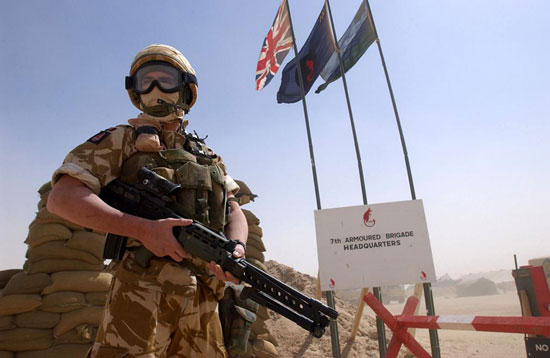 5.56mm Light Support Weapon (LSW) - A member of the 1st Battalion, the Duke of Wellington's Regiment, guards the entrance to 7 Armoured Brigade Headquarters, in the Kuwaiti desert.