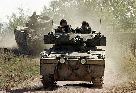 Pristina, Kosovo, 16/09/2000: Sabre Patrol - A Sabre Combat Vehicle Reconnaissance (Tracked) leads the way, followed by a Warrior Infantry Combat Vehicle, during a patrol near the border with Serbia. 