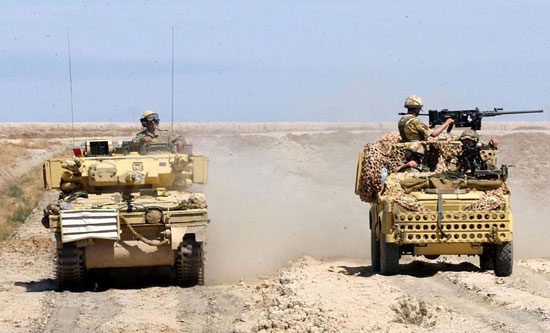 OP TELIC, Near Basra, Iraq, 02/04/2003: 'D' Squadron, the Household Cavalry Regiment, in their Scimitar Armoured Reconnaisance Vehicle (left), hand over their area of resposiblity to the 1st Battalion, the Parachute Regiment, in their Land Rover TUM WMIK (Truck Utility Medium Weapon Mount Installation Kit) Vehicle.