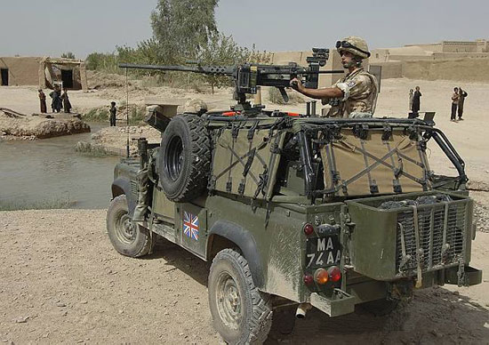 A British Weapons Mount Installation Kit (WMIK) Land Rover with a 50 calibre machine gun mounted on top provides security, whilst on patrol north of Lashkar Gar.
