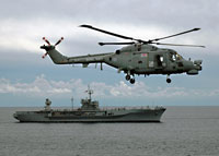 Royal Navy Lynx HMA 8 flies near the US Sixth Fleet flagship USS Mount Whitney 