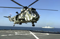 Royal Navy Westland Sea King HC 4 prepares to land aboard the U.S. Military Sealift Command (MSC) ship USNS Pecos 